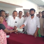 MLA Anil Jadhav attended a cheque distribution program in Thalamadugu, handing out a total of ₹15,01,740 to beneficiaries. He urged the government to fulfill its promises without deception.