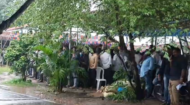 Despite heavy rains, eager applicants lined up at the Collector's office in Amalapuram for liquor shop licenses through the lottery system, hoping to secure their chance.