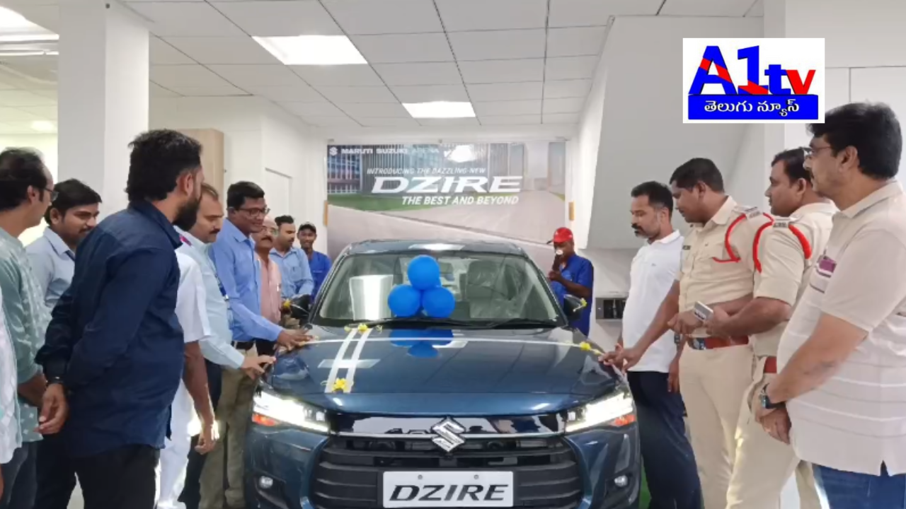 The new version of Dzire was launched at Varun Maruti showroom near Kurupam Road, led by CI Hari and manager Ramesh, with prominent locals attending.