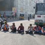 Farmers in Asifabad district are protesting at Adilabad X Road demanding the purchase of cotton. They seek immediate unloading of cotton from trucks and relief from extra charges.
