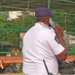 Rules for public, exemptions for officials? Traffic constable caught riding without a helmet while talking on the phone.