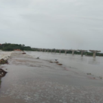 Heavy rains in Kadapa district have filled reservoirs, leading to water release from Mylavaram, flooding the Pennar River and affecting local transportation.