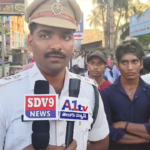 Amalapuram Traffic SI Yesubabu educated youth on road safety, helmet usage, and traffic rules at the Red Bridge.
