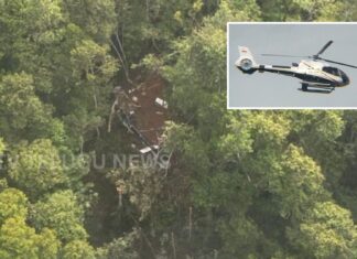helicopter crash site in west kalimantan forest area with rescue teams searching victims