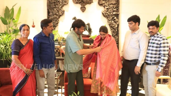 Megastar Chiranjeevi felicitating TGEAPCET topper M. Rushi and presenting her a laptop